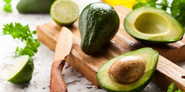 Fresh avocado sliced on a cutting board