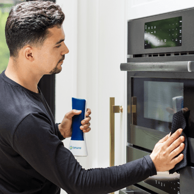 man using tersano product to clean stove