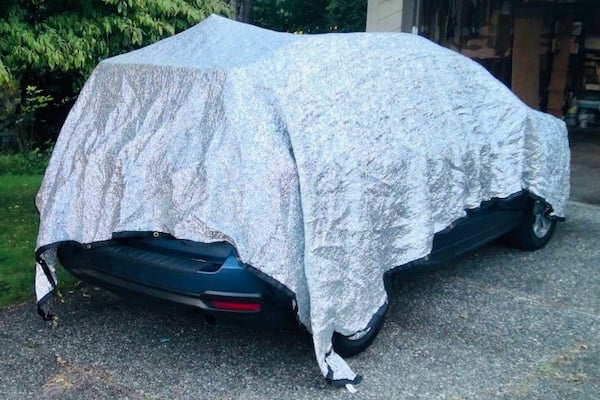 aluminet over car with open hatch and dog crate in back