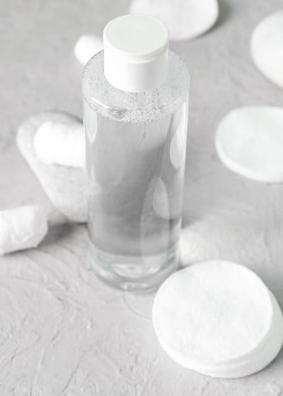 bottle of pet ear cleaner and cotton pads