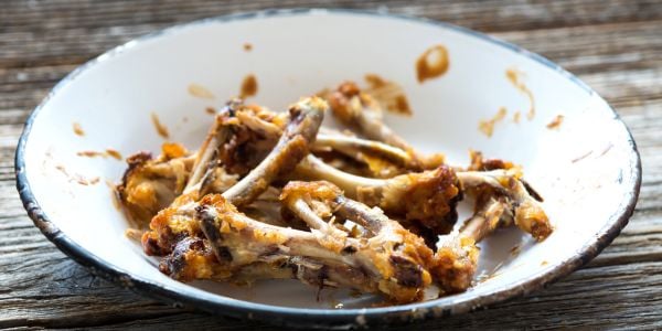 cooked chicken bones in bowl