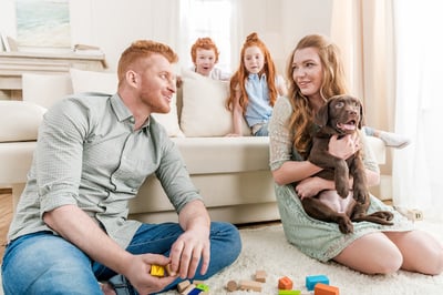 family with new puppy at home with children