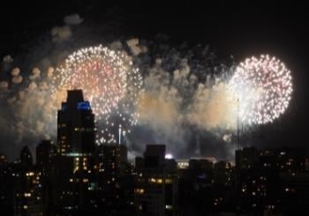 fireworks and smoke over city skyline