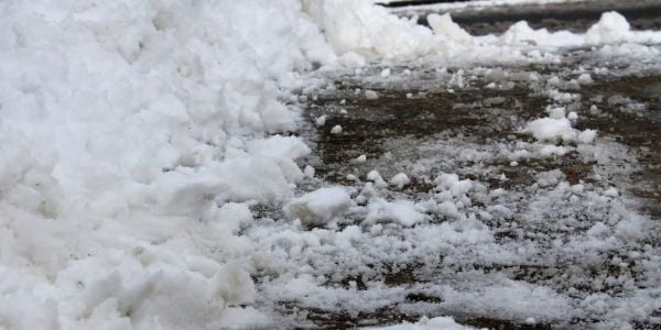 slushy snow melting on the sidewalk