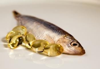 small fish next to fish oil capsules
