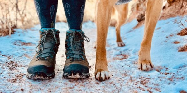 woman and dog feet on a salted hiking trail